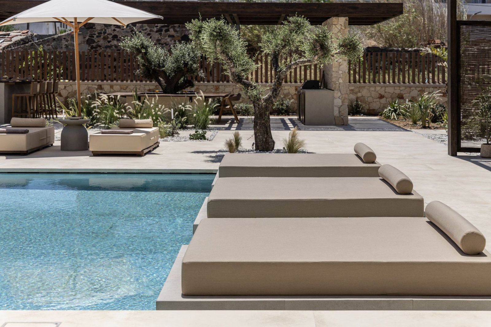 Daybeds beside the pool in the Elea courtyard