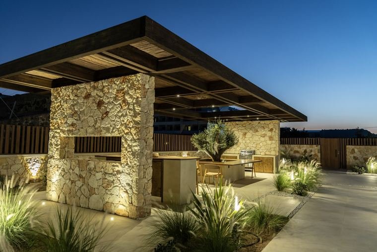 The stone pergola and BBQ at night