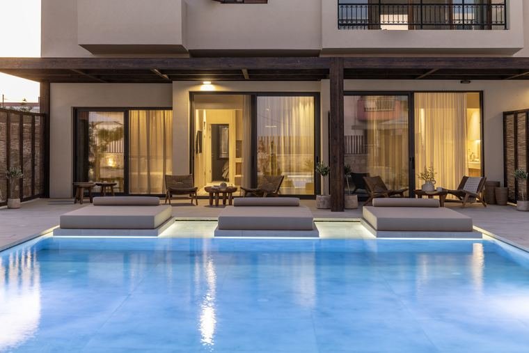 The suites at dusk, pool lit blue