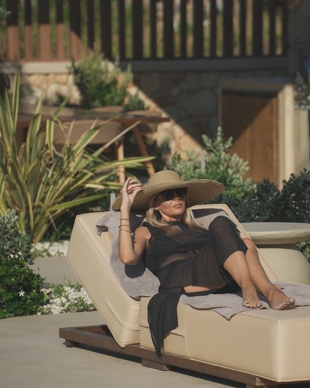 Guest relaxing on a sunlounger in the shade