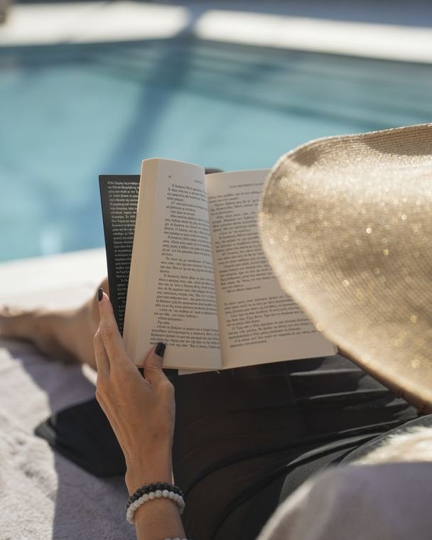 Reading under a straw hat